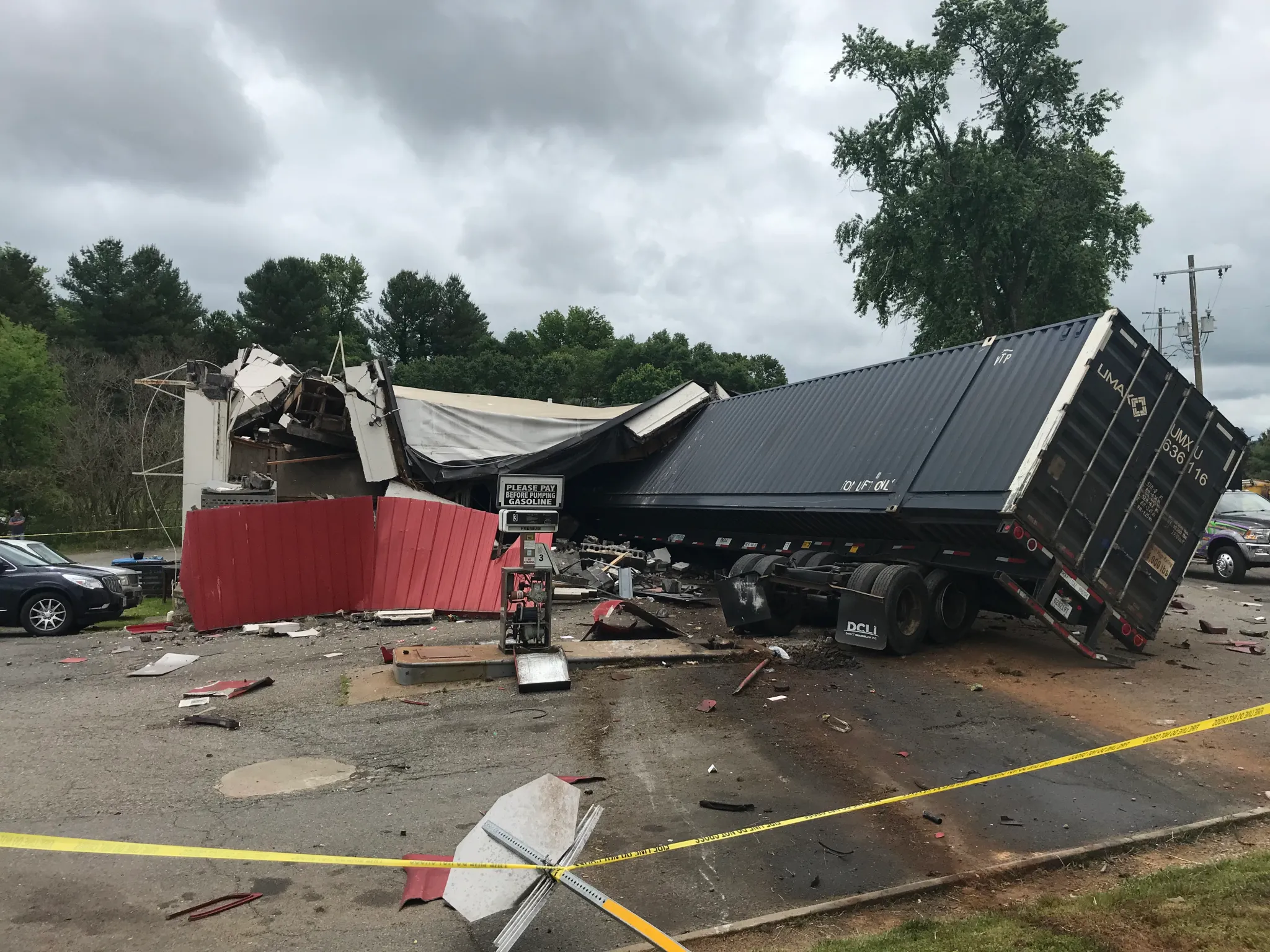 Tractor trailer lying sideways in road after accident.